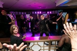 Band playing to the wedding guests as the crowd dances on the floor in front of them