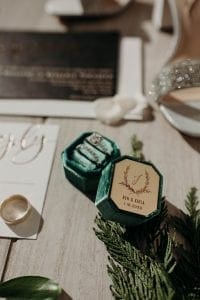 Emerald green ring box with wedding stationery suite