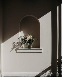 Wedding bouquet sitting on a ledge in a vase