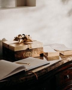 Brown card box guestbook and wedding programs sit out on a table