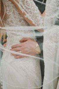 Grooms hands resting on the brides waist